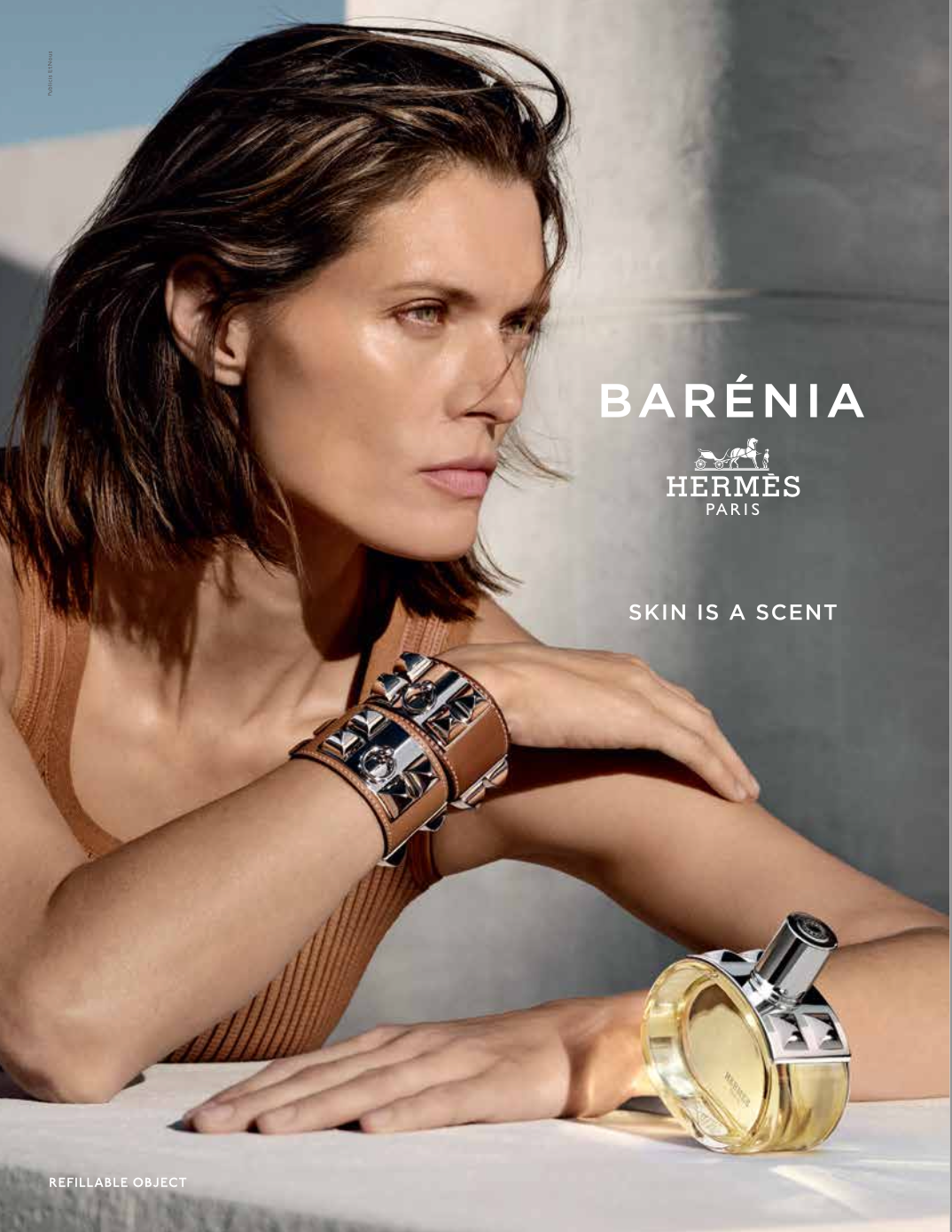 Woman with leather bracelet and perfume bottle, Hermes ad.