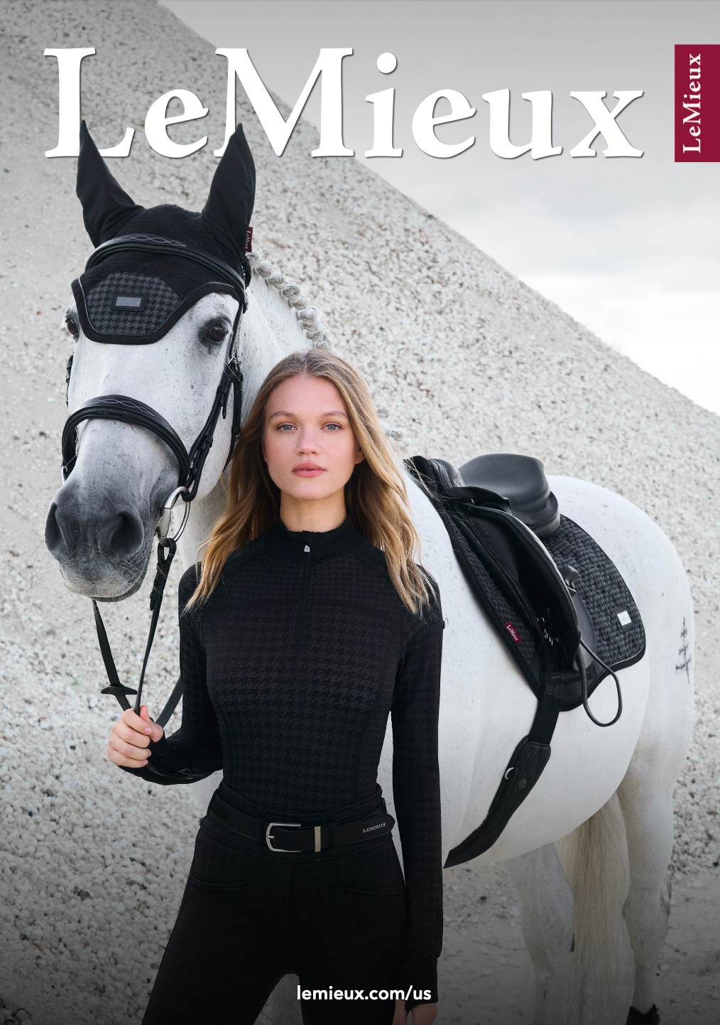 Woman in black riding attire with a white horse, LeMieux branding.