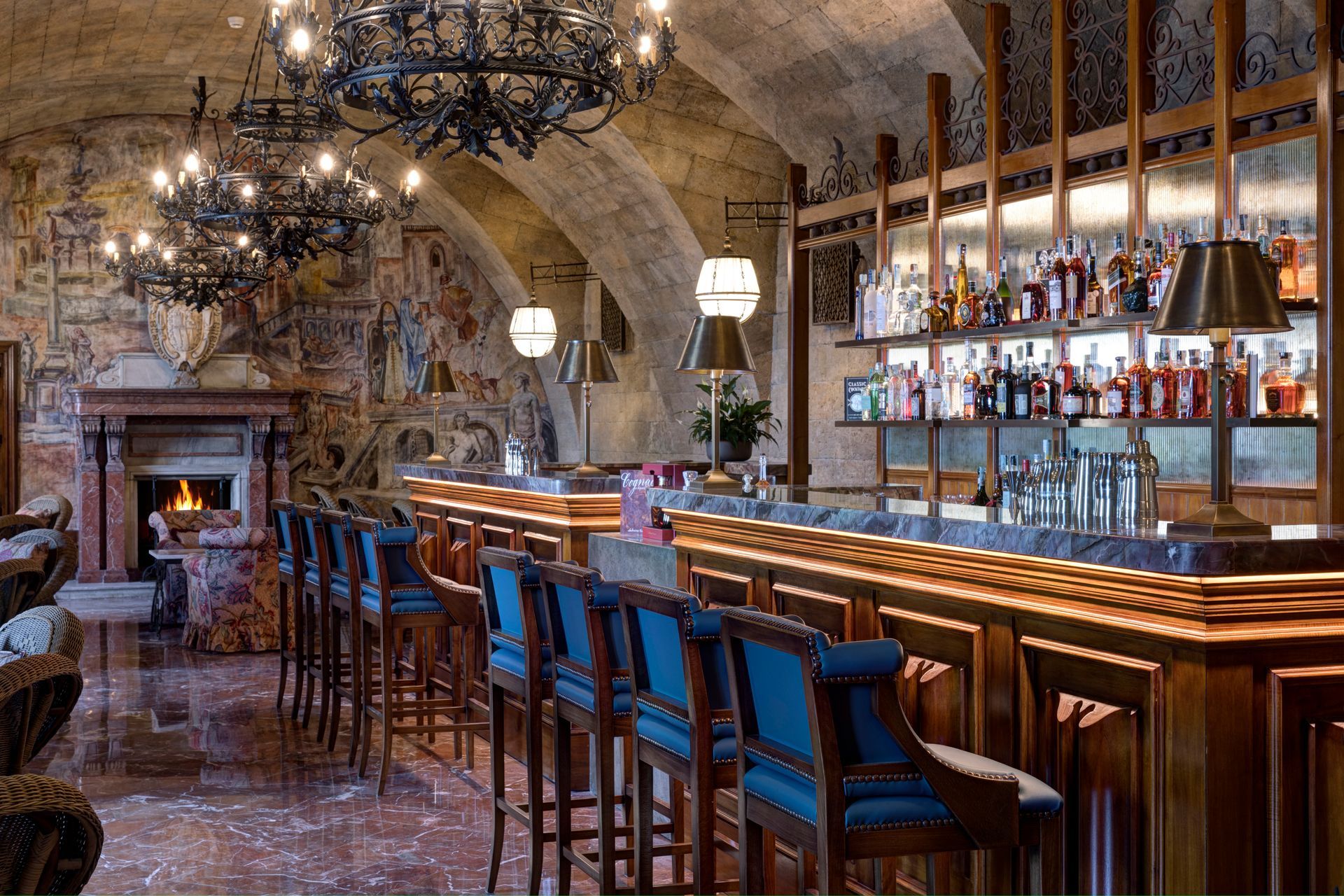 A long bar with a lot of bottles on it