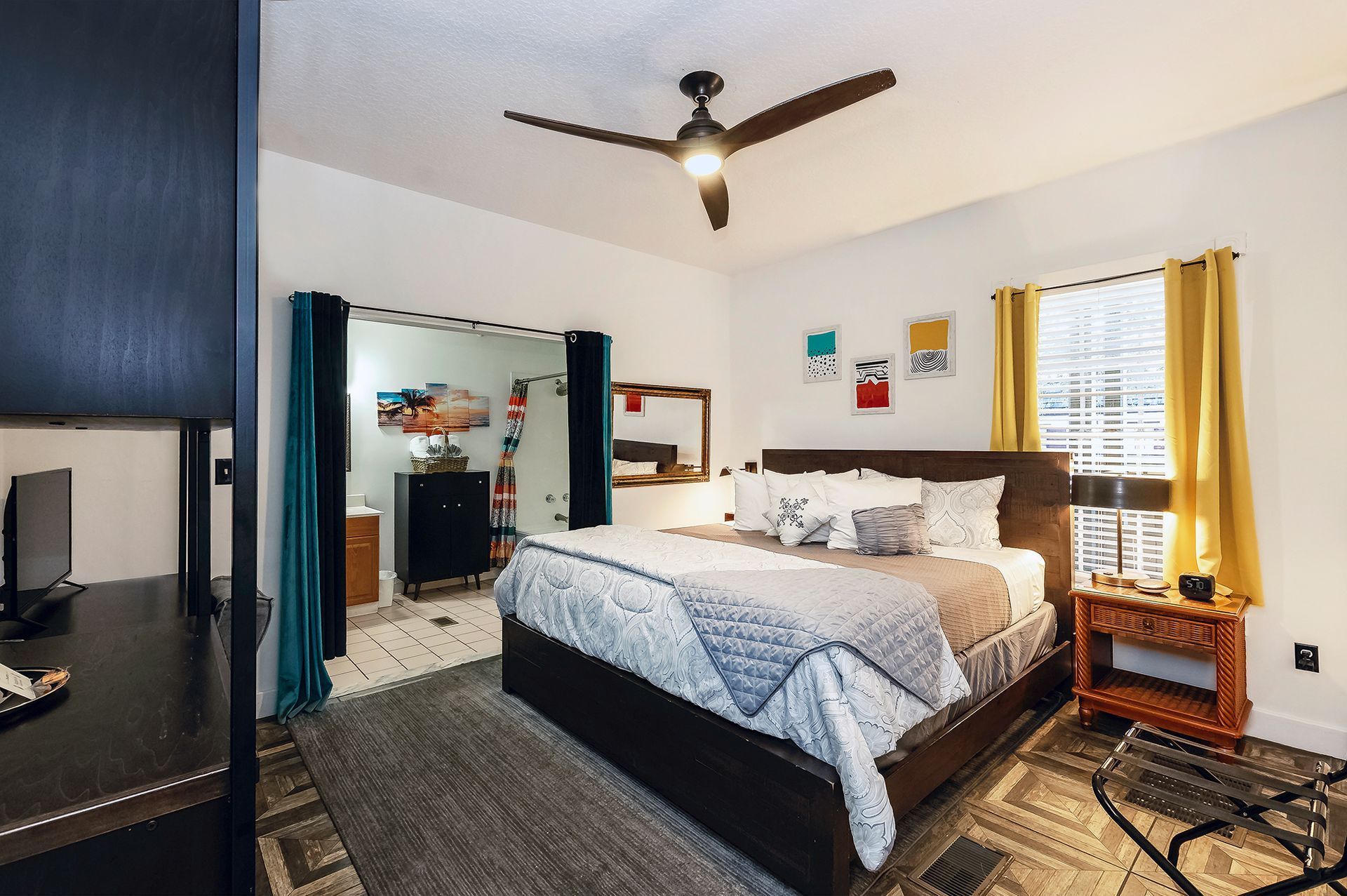 a bedroom with a large bed and a ceiling fan