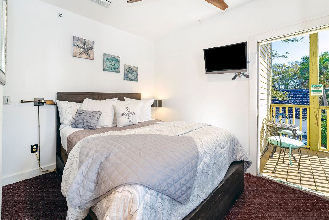 a bedroom with a king size bed and a flat screen tv .