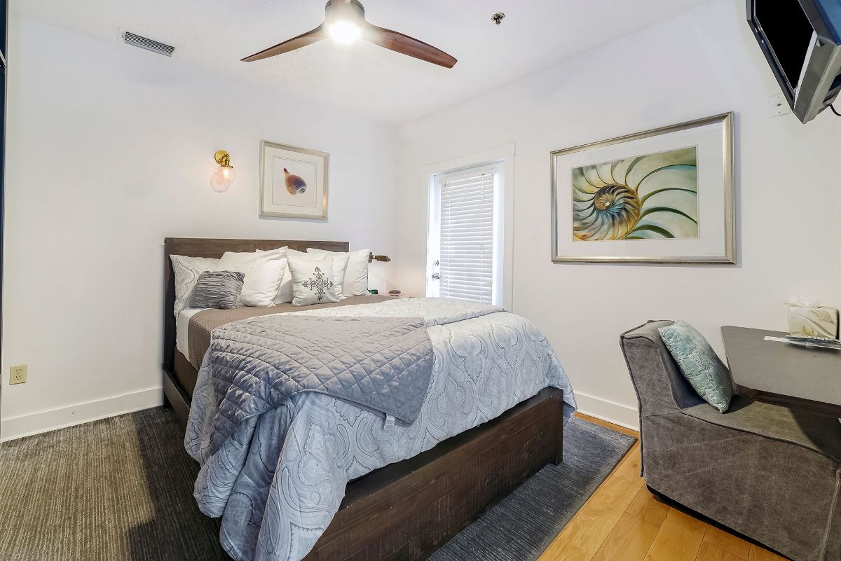 a bedroom with a king size bed and a ceiling fan