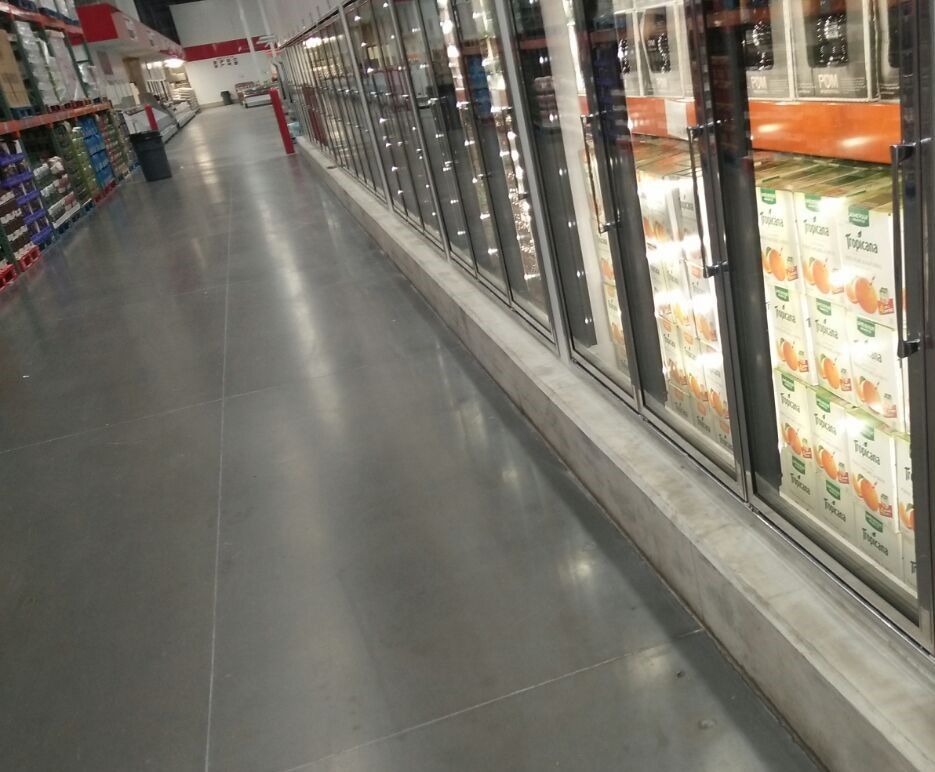 An aisle in a grocery store with a lot of boxes in the freezers