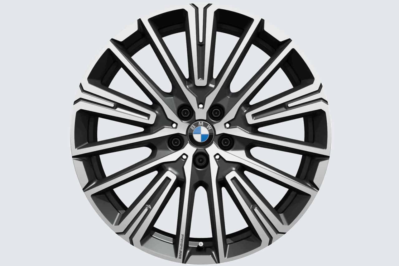 A close up of a bmw wheel on a white background