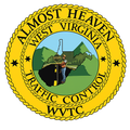 West Virginia Traffic Control emblem with road worker, mountains, and a yellow rope border