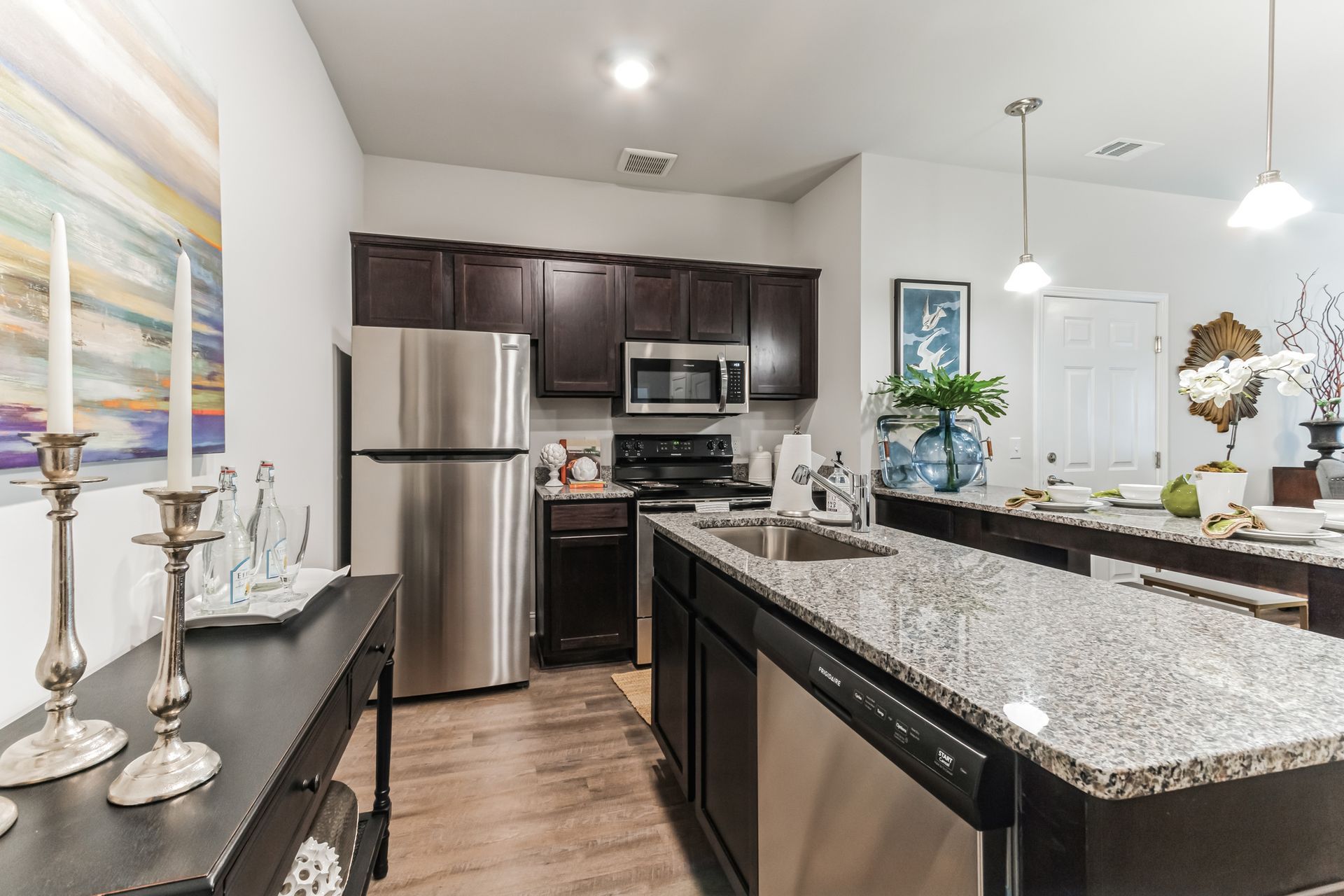 Open concept kitchen with stainless appliances and granite countertops and dishwasher