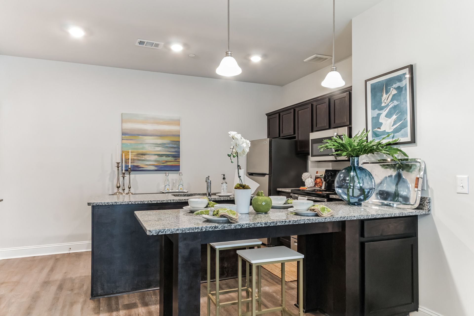 Open concept kitchen with stainless appliances and granite countertops and built-in dining counter