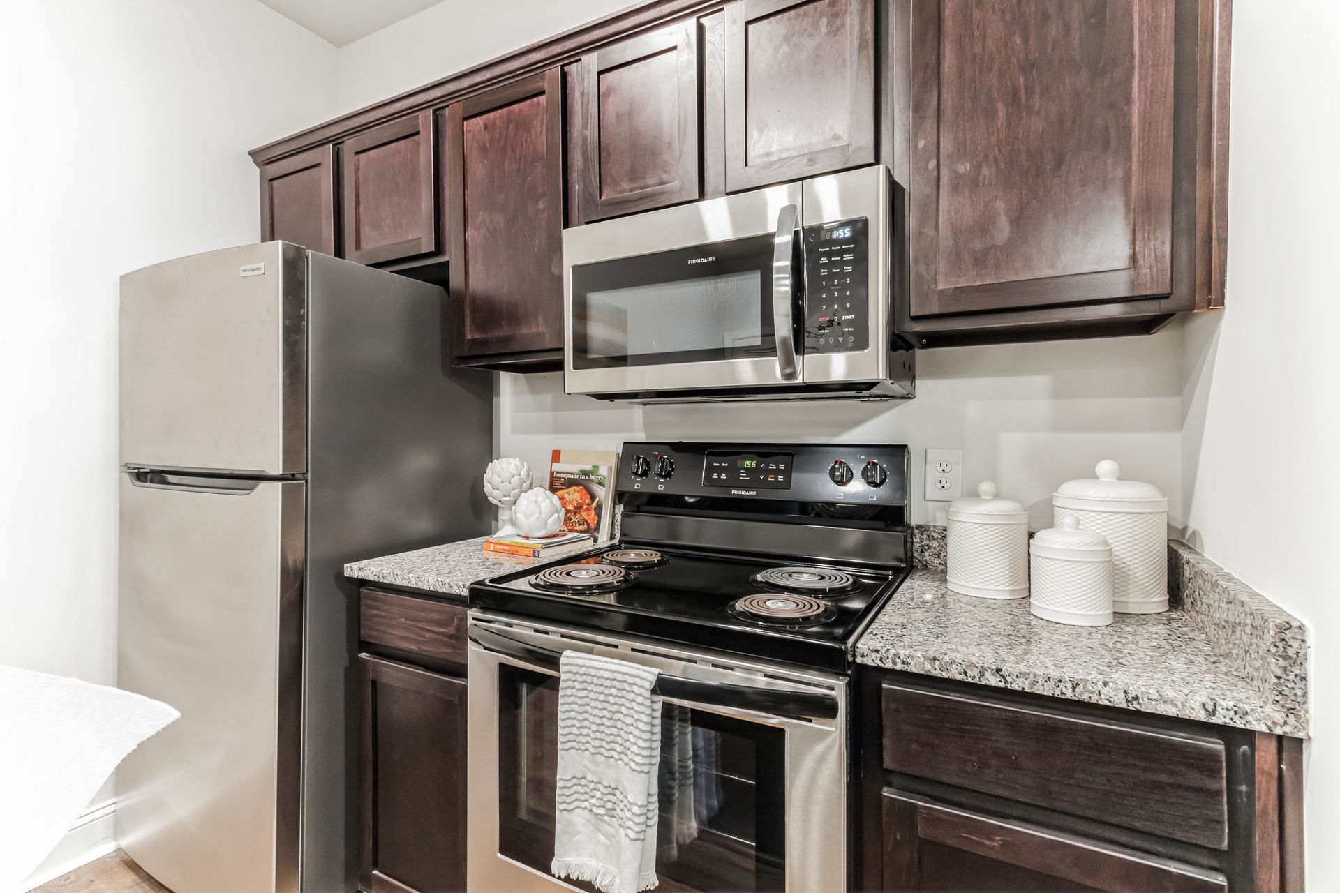 Open concept kitchen with stainless appliances and granite countertops