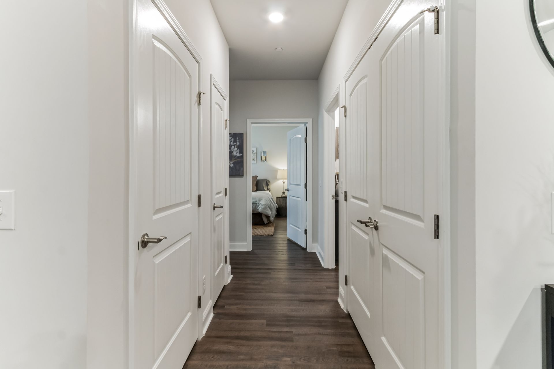 Hallway with pantry, coat closet, and laundry
