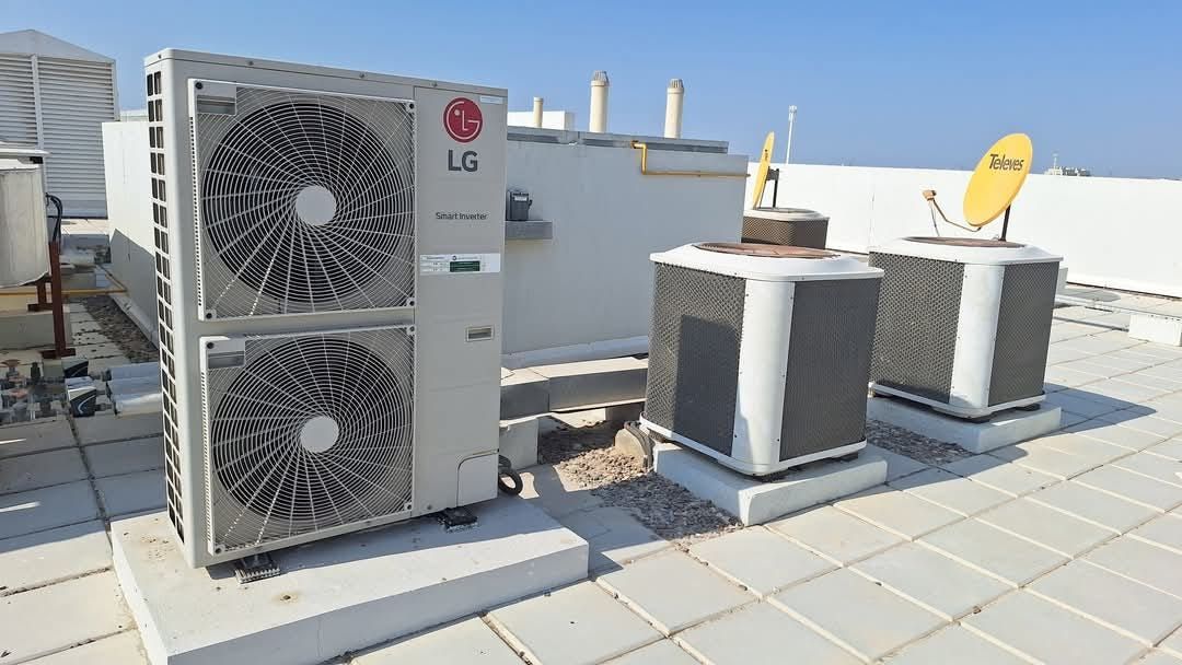 An air conditioner is sitting on the side of a house.