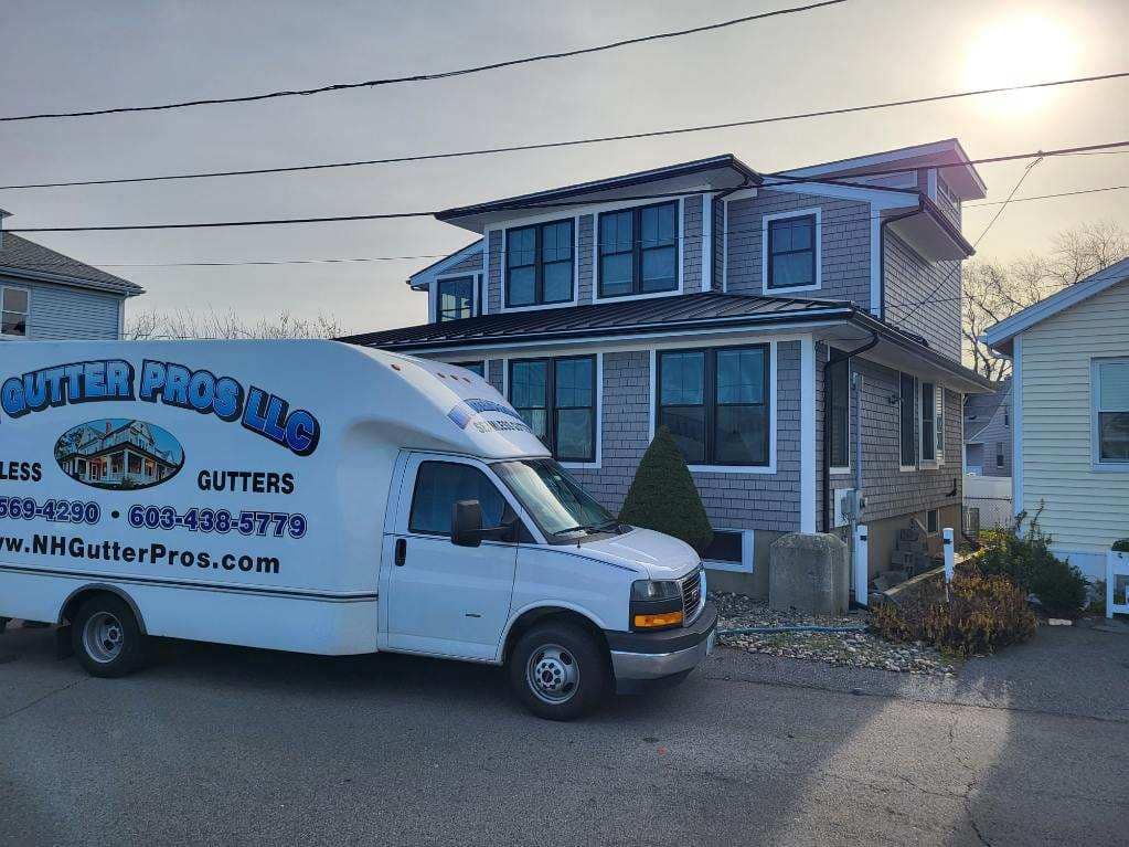 A white van is parked in front of a house.