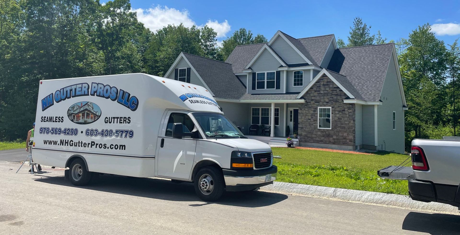 A white van is parked in front of a house.