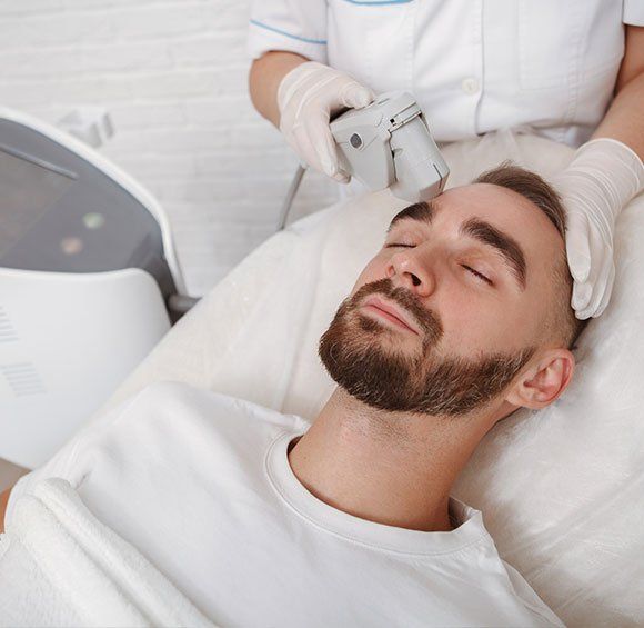 Man Getting Facial Treatment — Kailua,HI — Kailua Dermatology Associates Ltd Man Getting Facial Treatment — Kailua,HI — Kailua Dermatology Associates Ltd