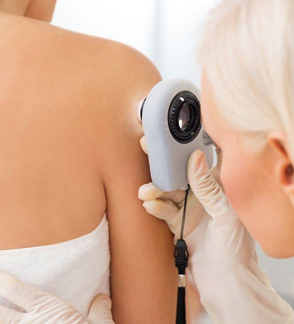 Dermatologist Checking Patient's Skin — Kailua,HI — Kailua Dermatology Associates Ltd Dermatologist Checking Patient's Skin — Kailua,HI — Kailua Dermatology Associates Ltd