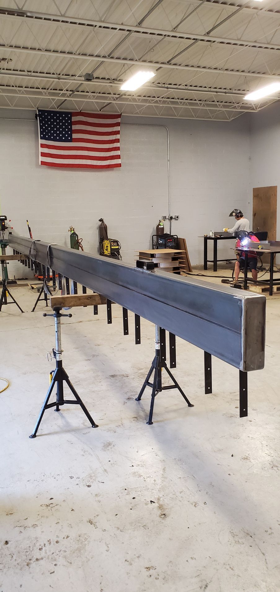 A large piece of metal is sitting on a table in a factory.