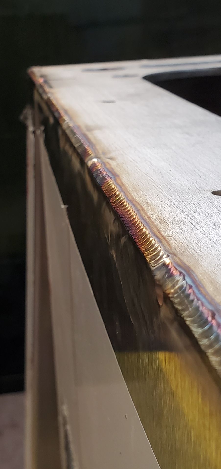 A close up of a piece of metal with a welded edge.