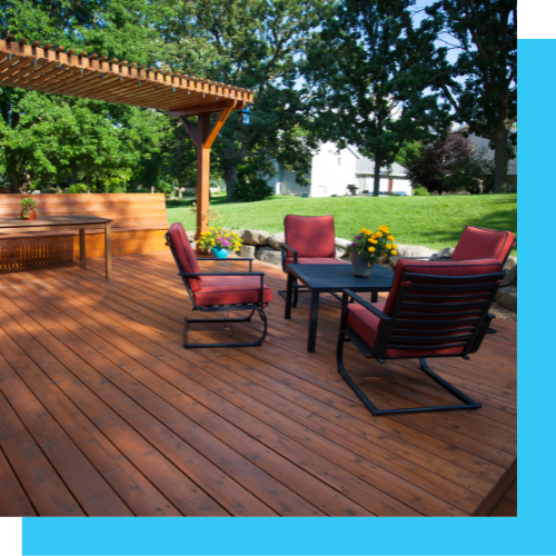 a wooden deck with chairs and a table under a pergola