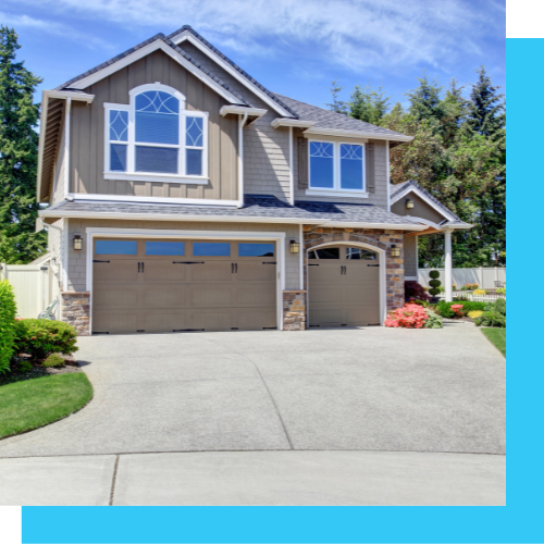 a large house with two garage doors and a driveway .