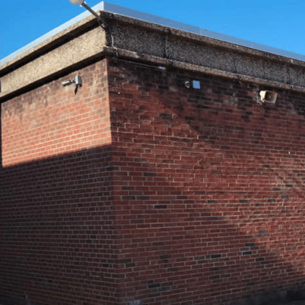 a brick building with a blue sky in the background