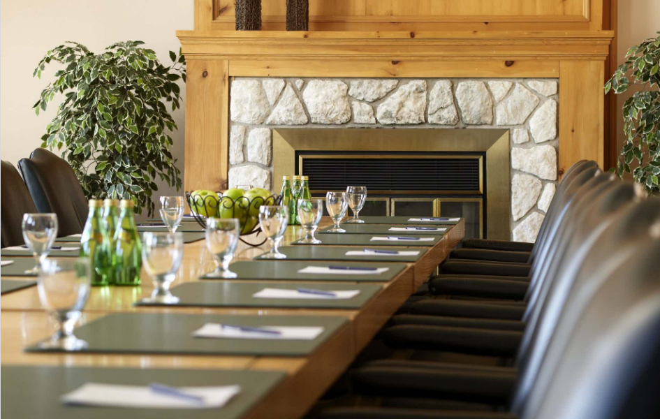 A long table with a fireplace in the background