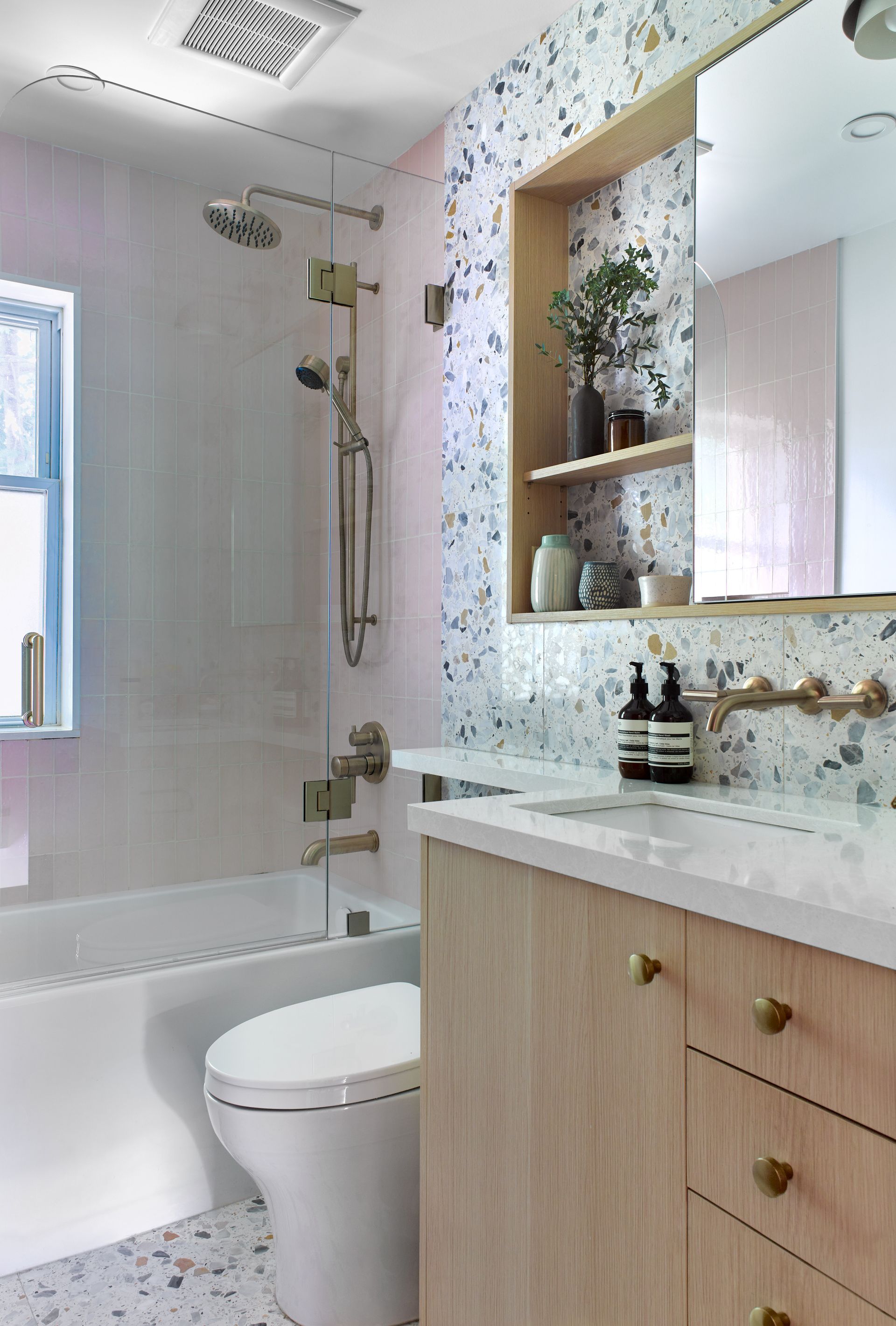 A bathroom with a toilet , sink , bathtub and shower.