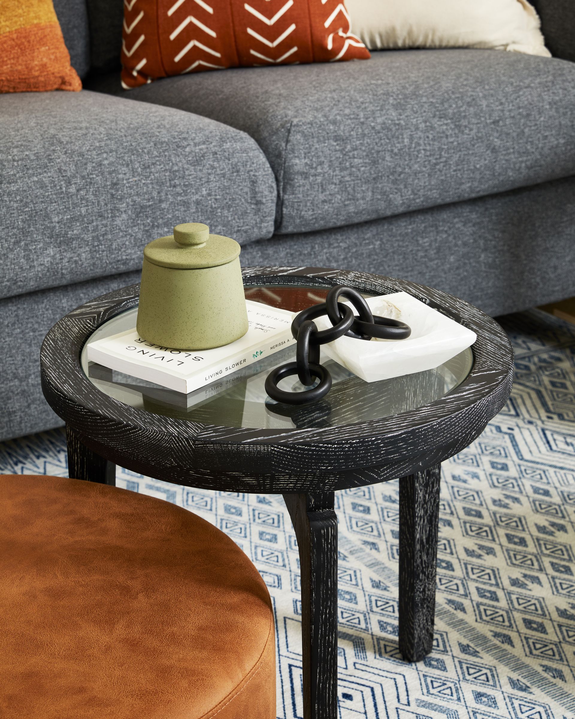 A living room with a couch and a table with a book on it.