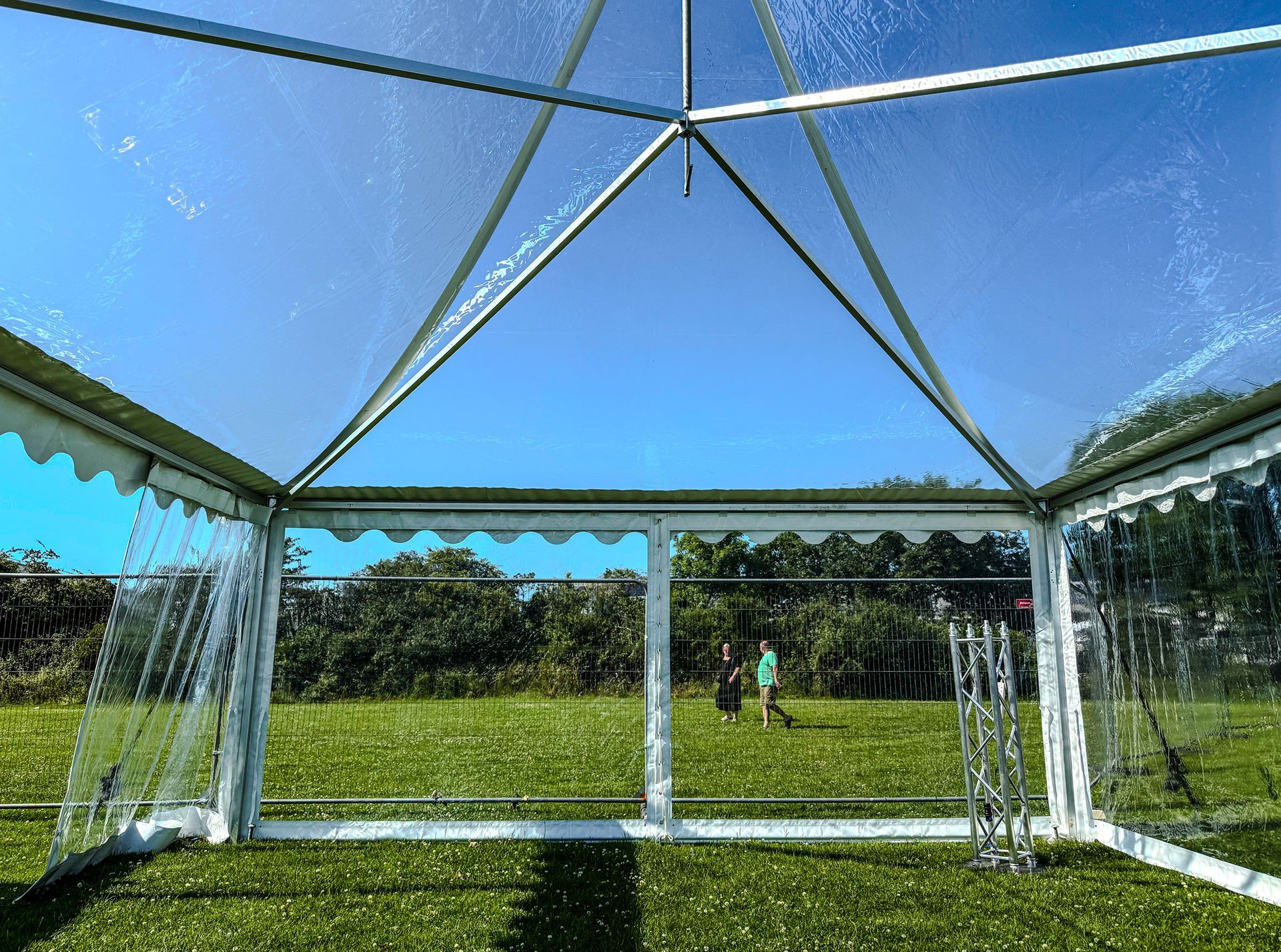 A clear tent with a blue sky in the background