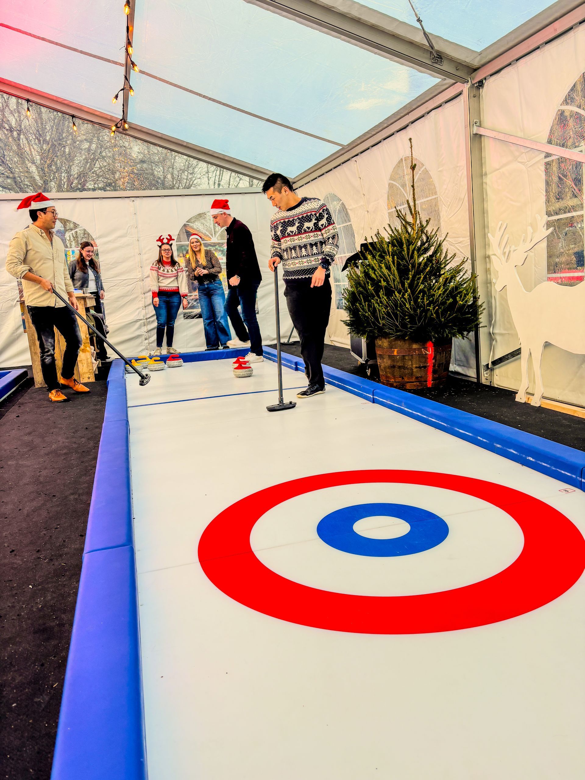 A group of people are playing a game of curling