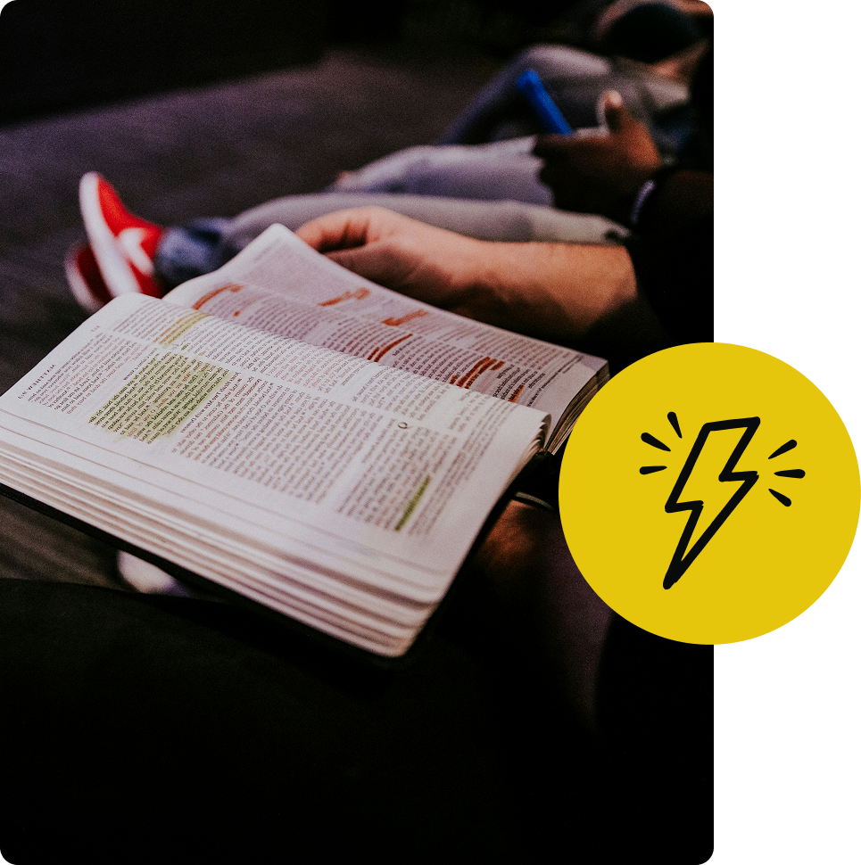 Person reading an open book on a couch, with a yellow lightning icon overlay.