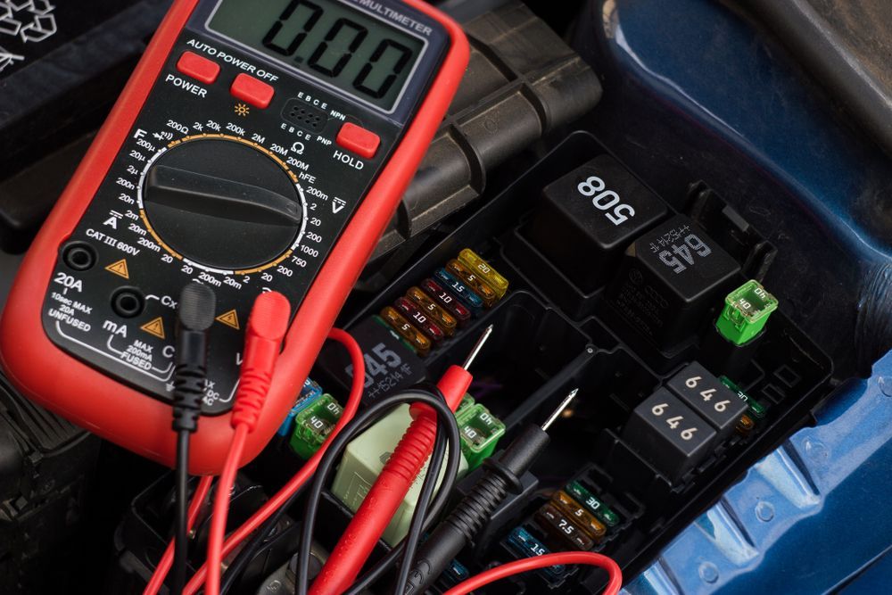 Multimeter Testing Fuses in a Car's Fuse Box — COOTA Automotive Services in Ballarat East, VIC
