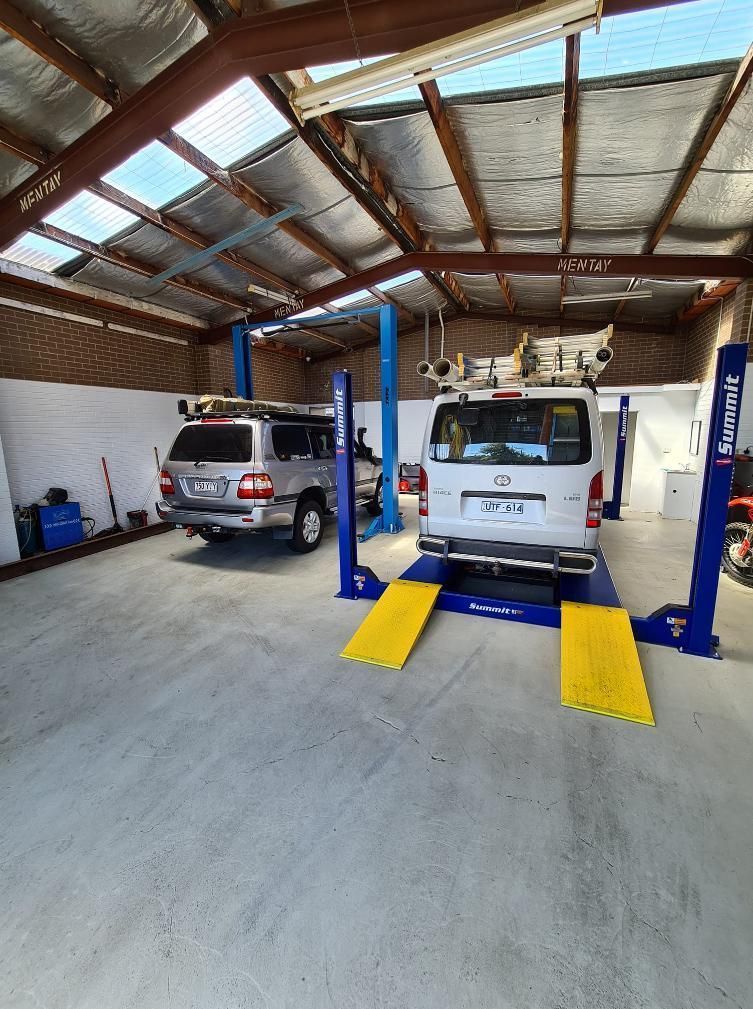 Two Vehicles on Lifts Inside a Garage — COOTA Automotive Services in Ballarat East, VIC