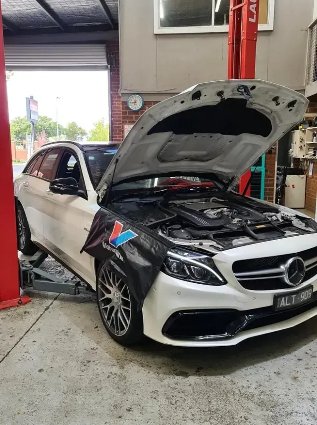 White Mercedes-benz Station Wagon on a Lift — COOTA Automotive Services in Ballarat East, VIC