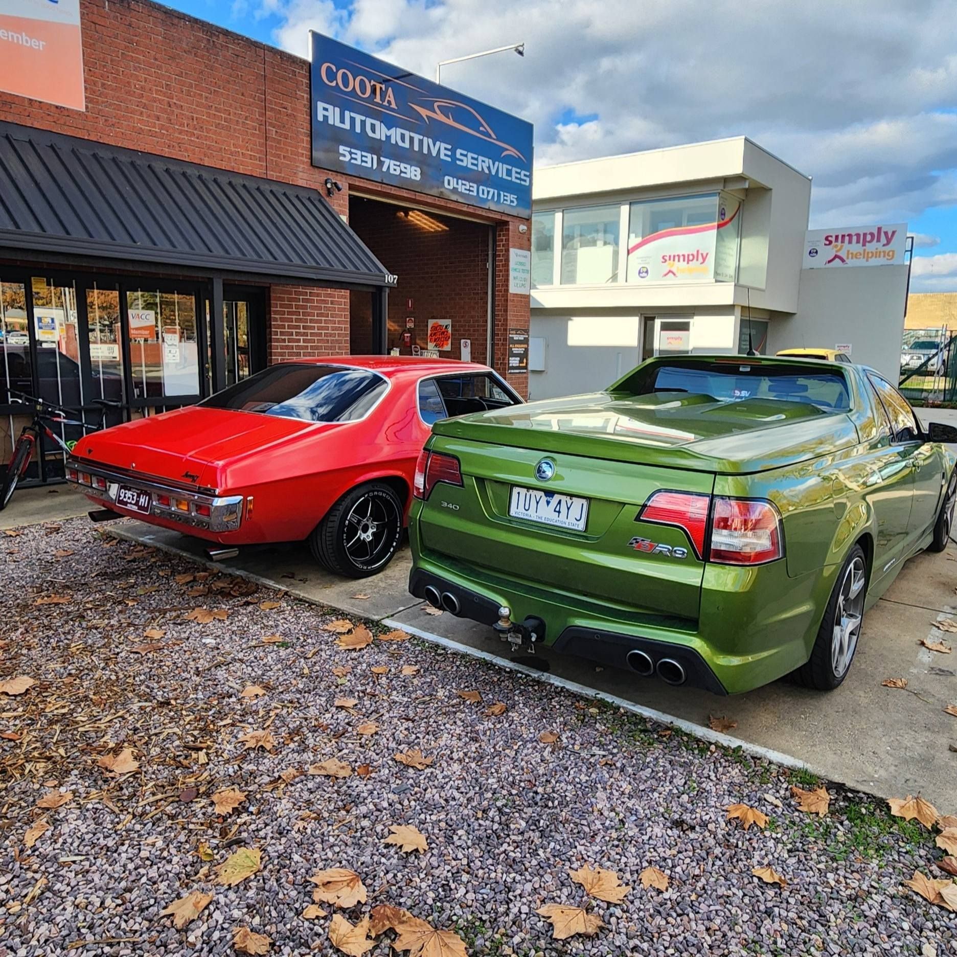 Red classic car and green ute parked outside an automotive service shop. — COOTA Automotive Services in Ballarat East, VIC