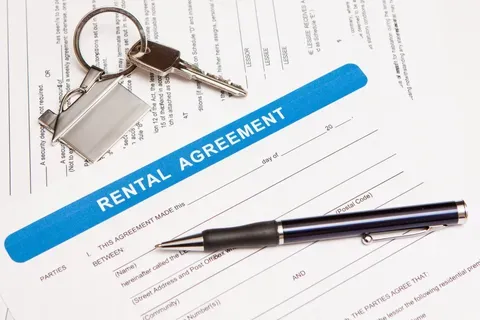 Rental agreement contract next to keys and pen — Ponca City, Oklahoma — Village Green Apartments Rental agreement contract next to keys and pen — Ponca City, Oklahoma — Village Green Apartments