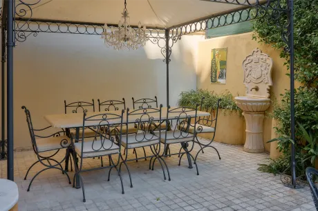 A patio with a table and chairs under a canopy