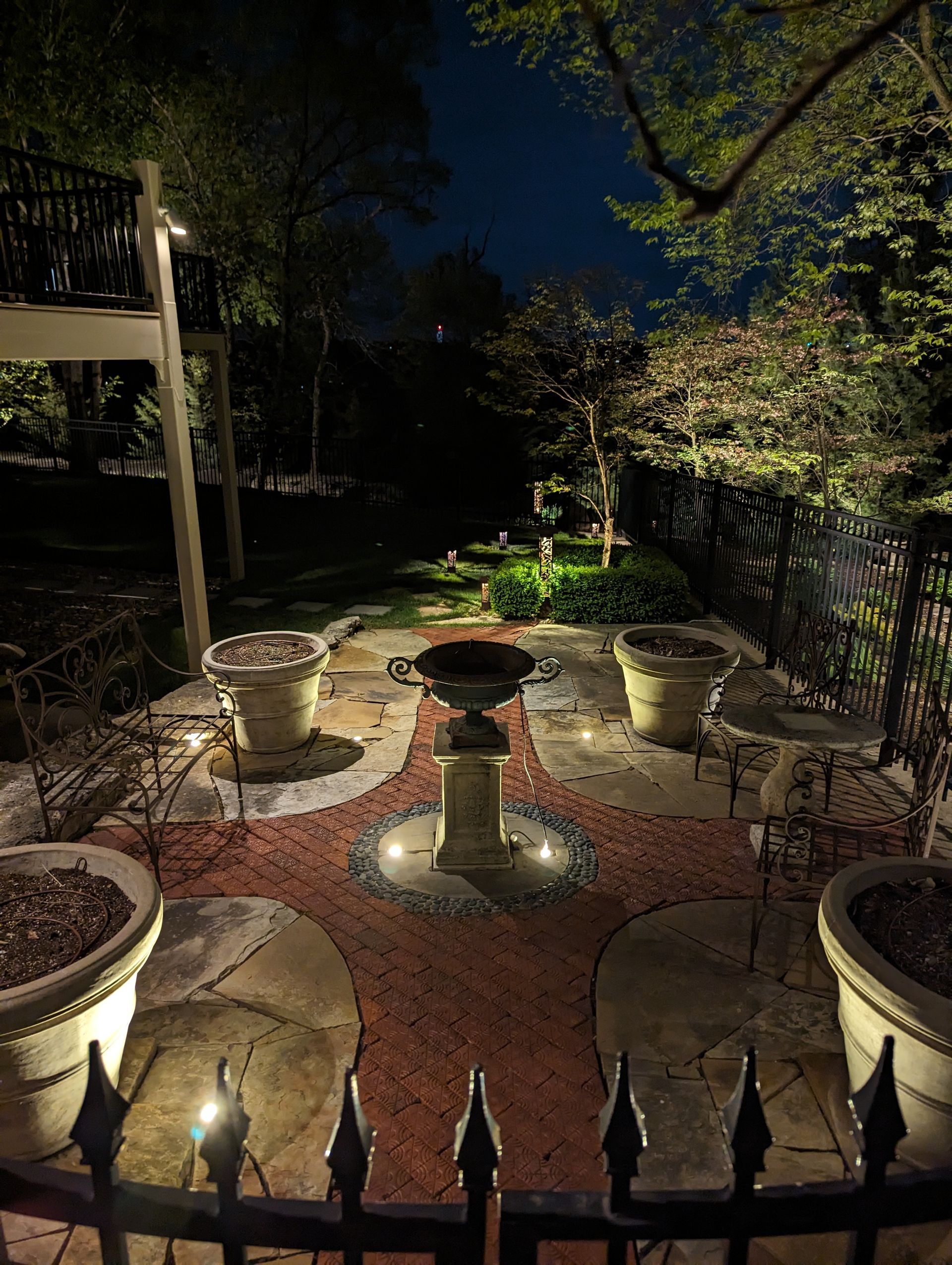 Luxury residential property with warm amber landscape uplighting at night