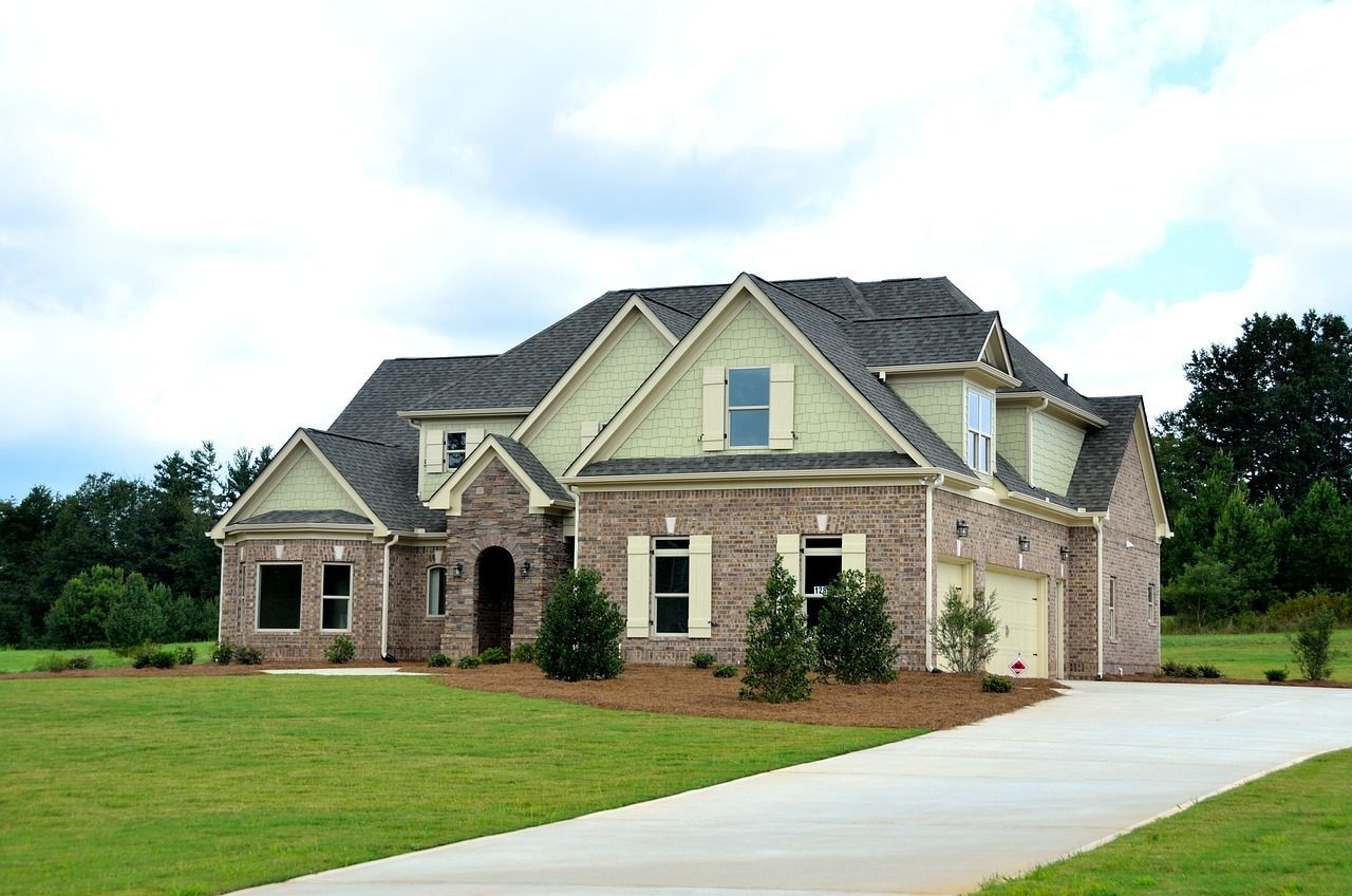 a large brick house with a driveway in front of it