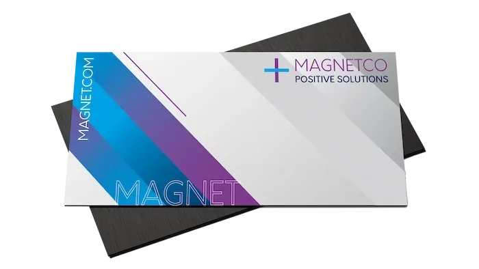 A MagnetCo business card with blue, purple, and grey geometric shapes, layered over a black magnetic base.