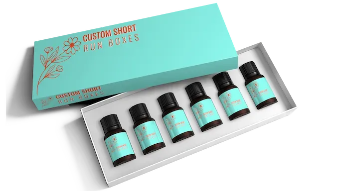 A teal branded box with floral detail open to reveal six small bottles with matching teal labels.