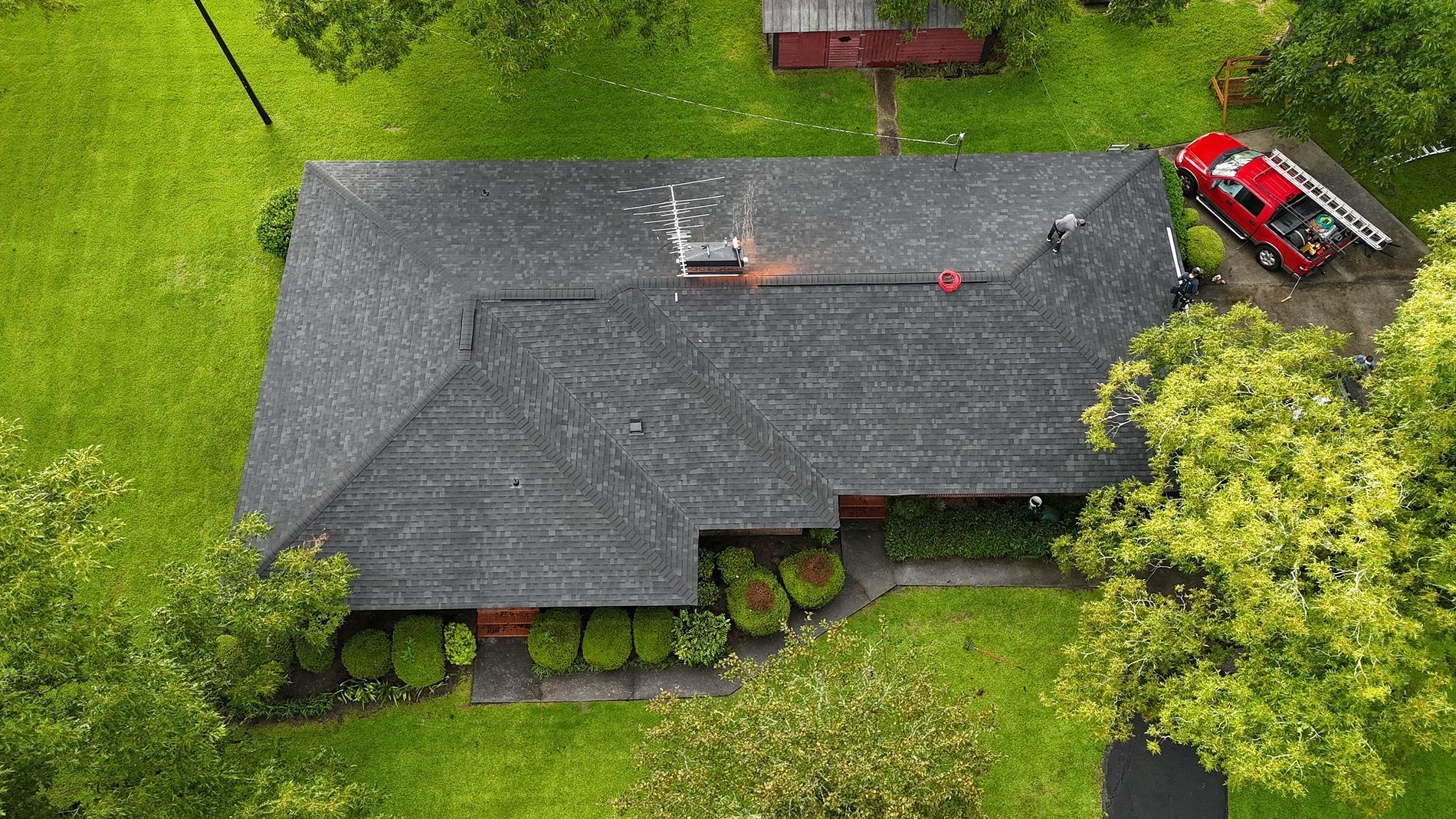 Overhead view of a house with a red fire truck parked in the driveway.