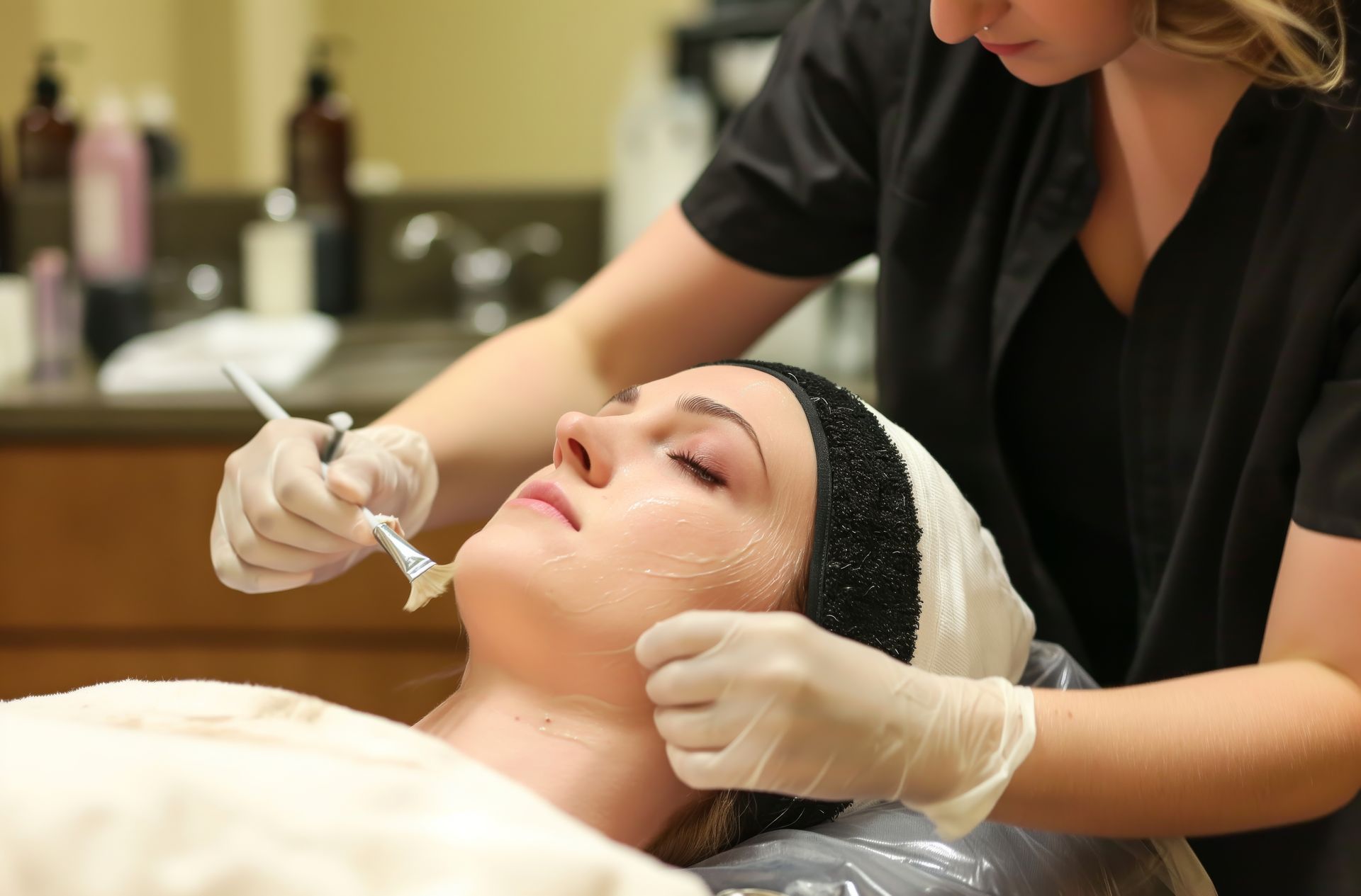 A woman is getting a facial treatment at a beauty salon.