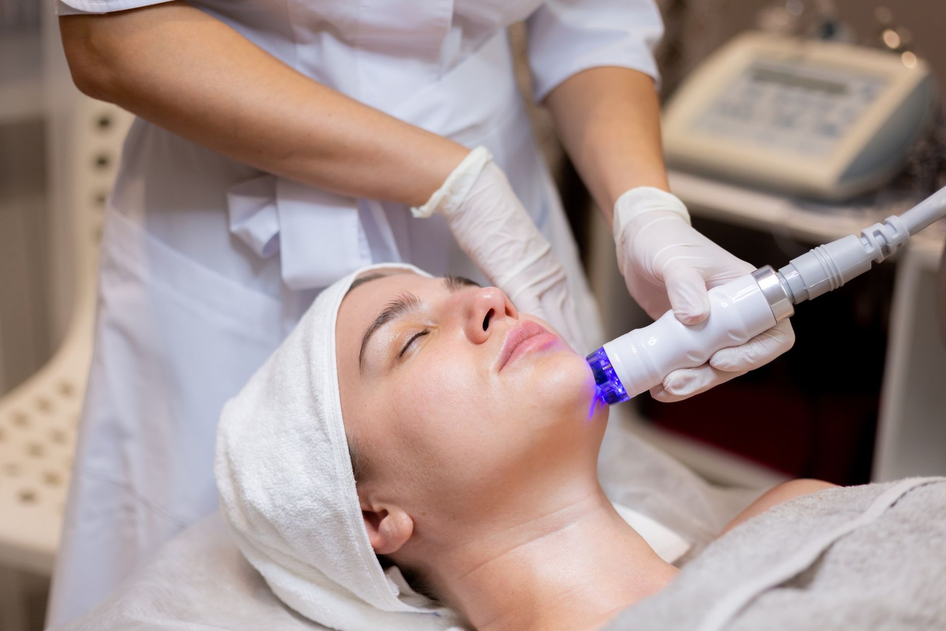 A woman is getting a facial treatment in a beauty salon.