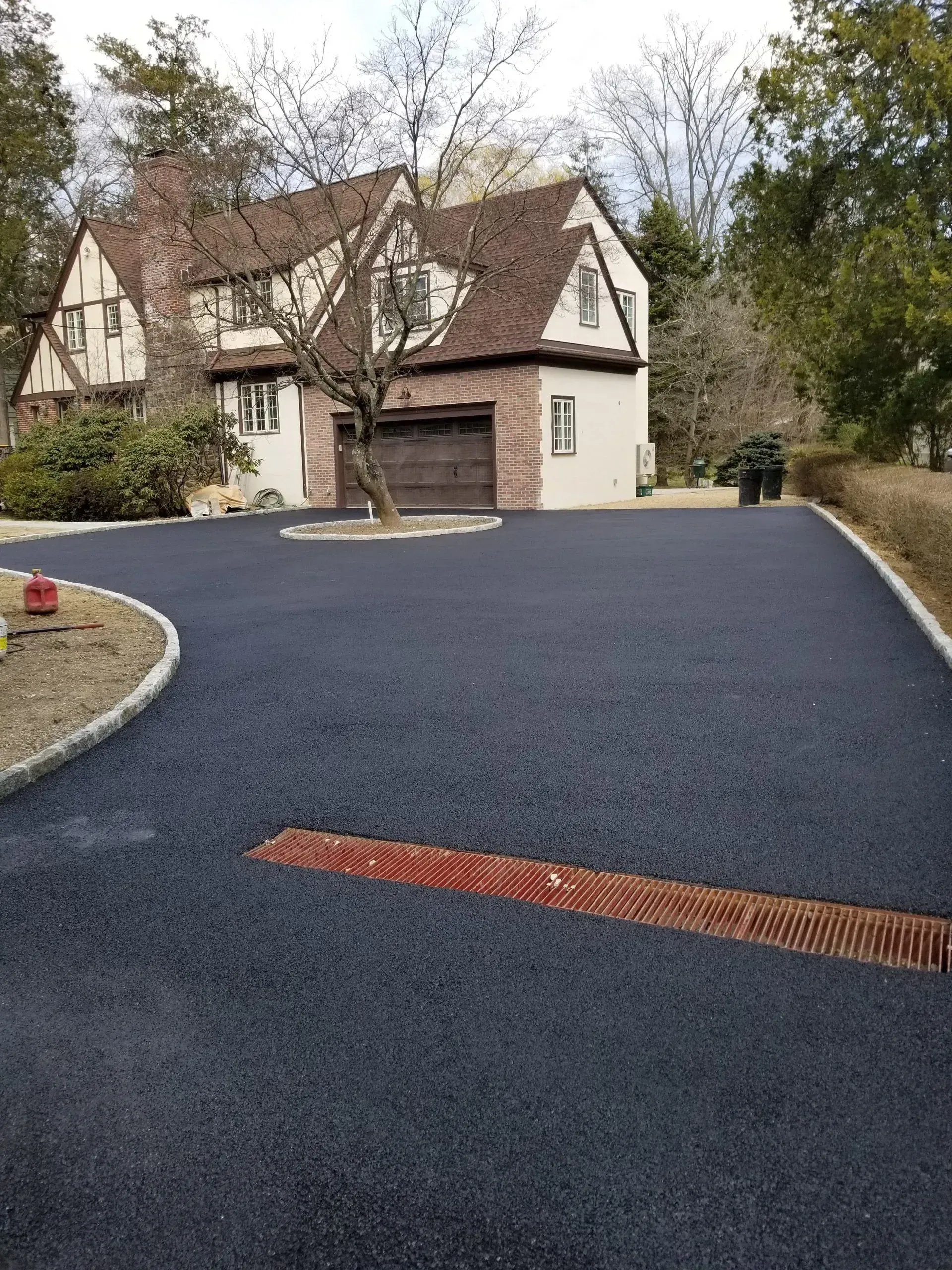A large house with a large driveway in front of it.