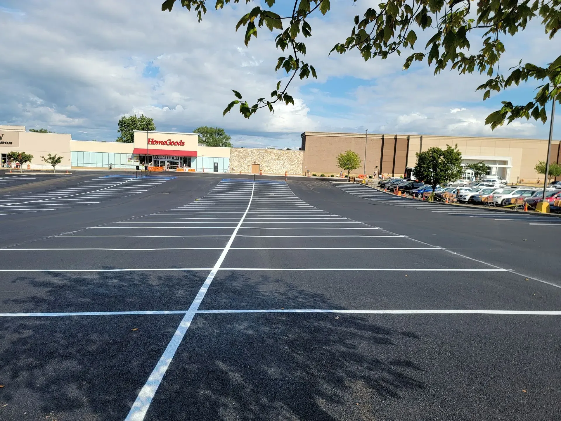 An empty parking lot with a store in the background.