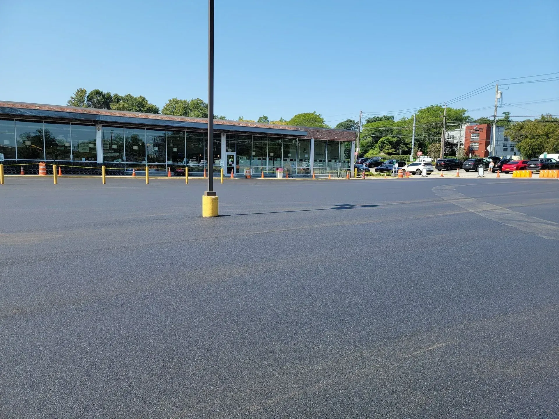 An empty parking lot with a building in the background.