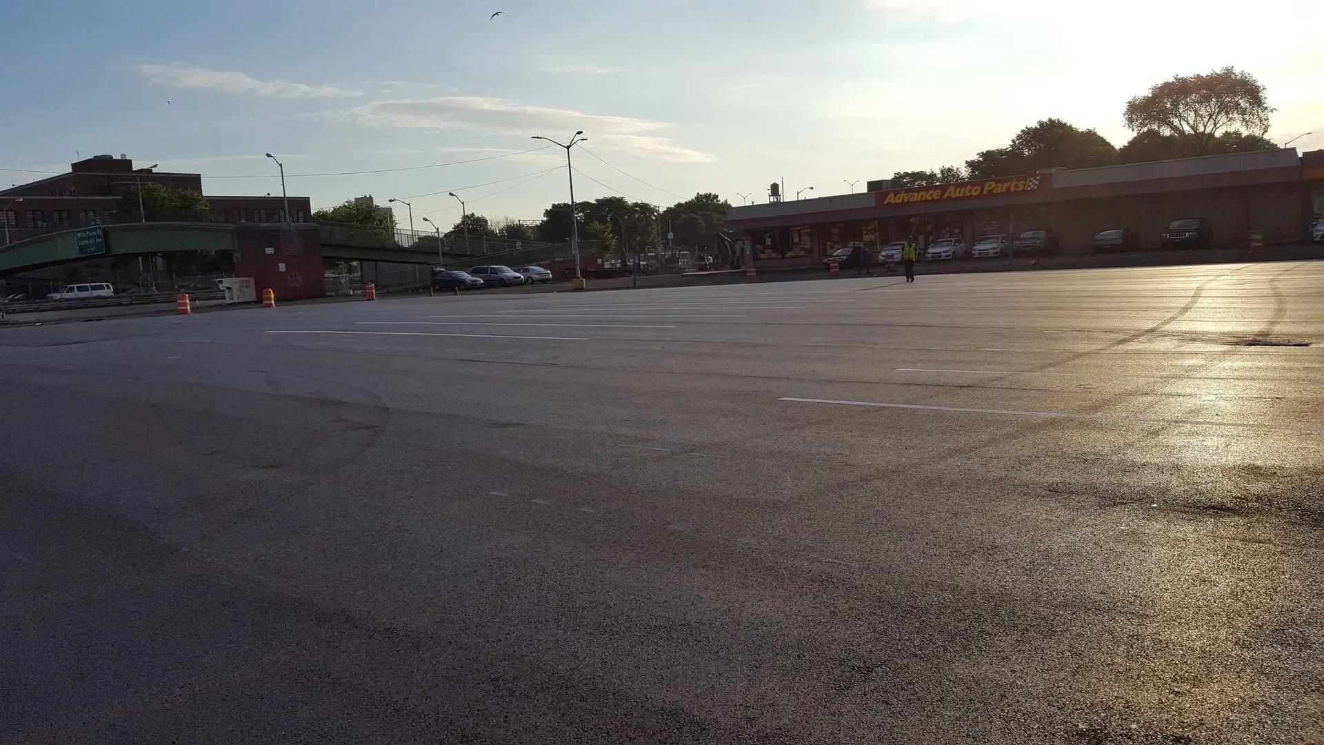 An empty parking lot with a building in the background.