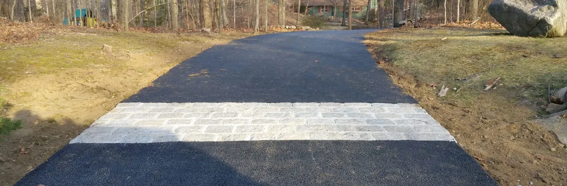 A black road with a white stripe on the side of it.