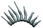A bunch of screwdrivers are sitting on top of each other on a white surface.