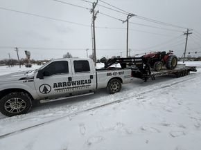 Equipment clearing snow from a commercial property