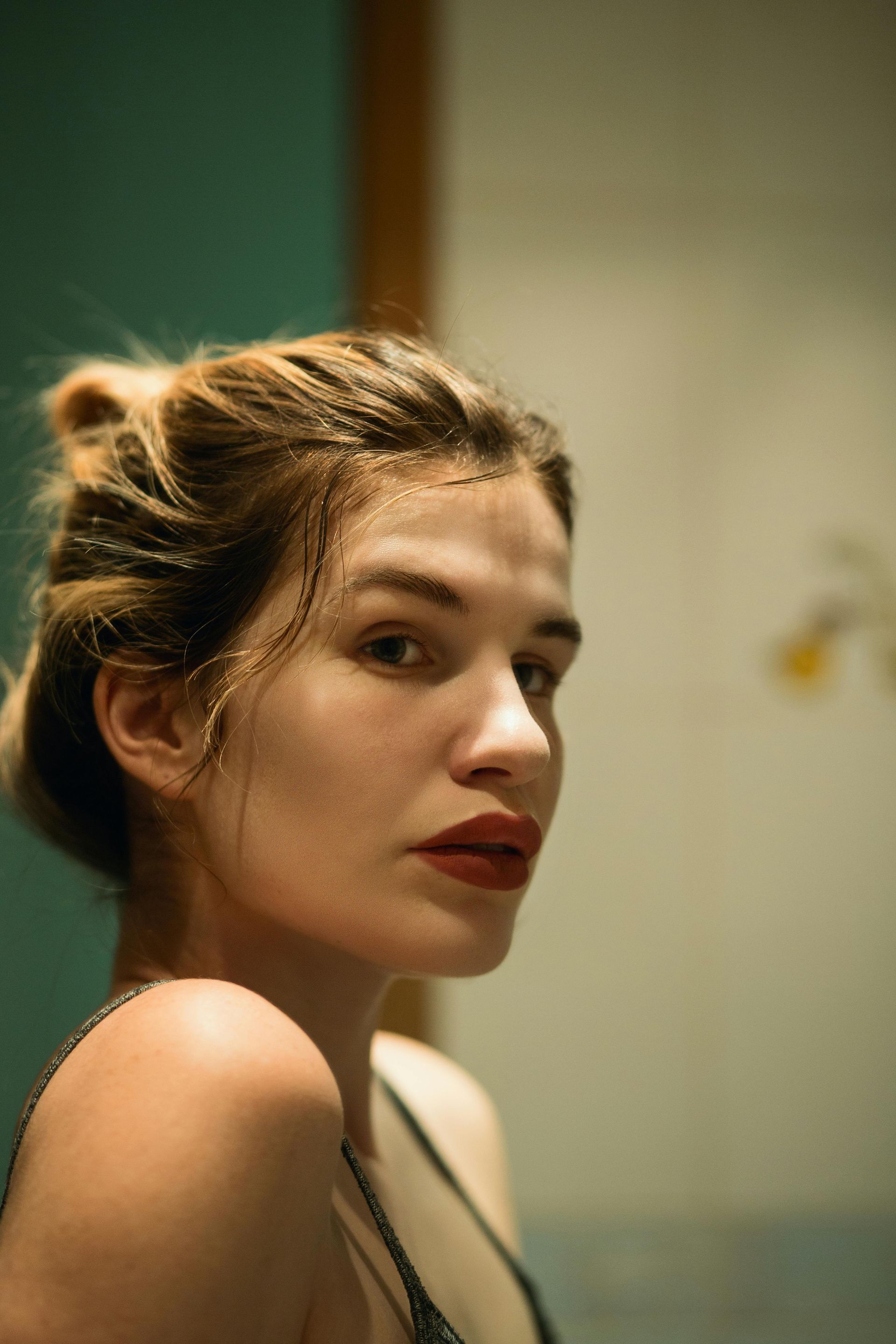 A woman is looking at herself in the mirror.